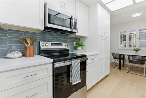 a kitchen with stainless steel appliances a stove microwave and cabinets