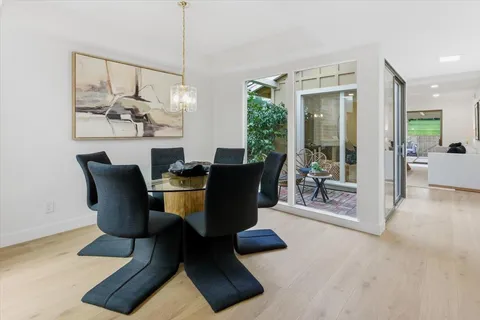 a view of a dining room with furniture wooden floor and chandelier