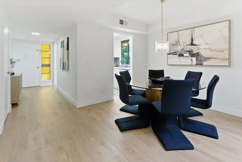 a living room with furniture wooden floor and a chandelier