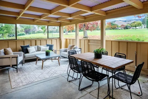 a view of a patio with a backyard table and chairs