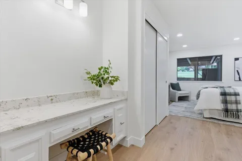 a en suite bathroom with a double vanity sink and a mirror