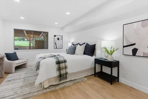 a spacious bedroom with a bed and a couch