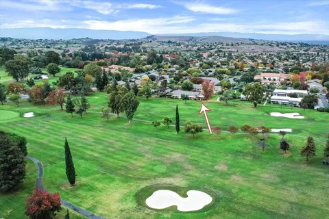 a view of a golf course with a swimming pool