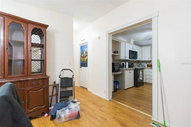 a kitchen with granite countertop a refrigerator stove and cabinets