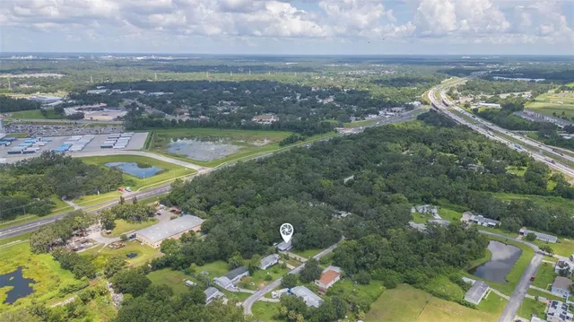 a view of a big yard with large trees