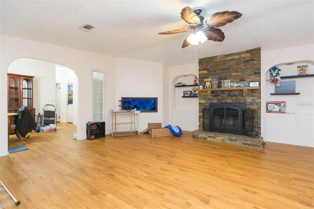 a view of a livingroom with a fireplace and a chandelier