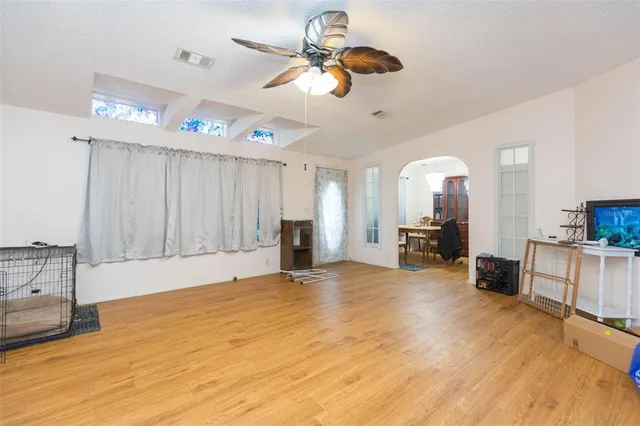 a view of a livingroom with furniture a ceiling fan and window