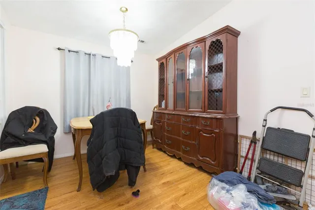 a living room with furniture a rug and wooden floor