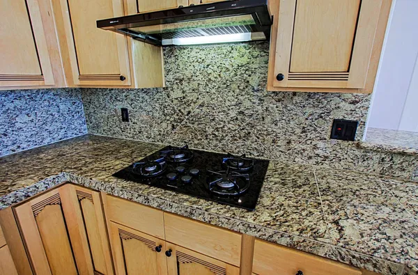 a kitchen with a sink stove and cabinets