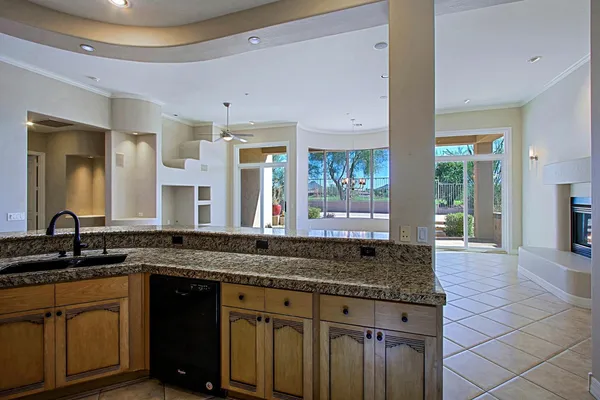 a kitchen with granite countertop a sink and a wooden cabinets