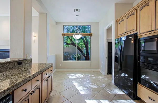 a kitchen with stainless steel appliances granite countertop a granite counter tops and a window