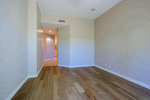 a view of a room with wooden floor