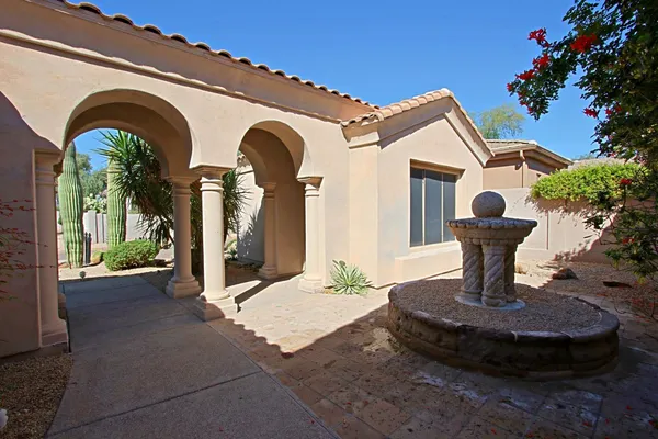 a front view of a house with garden