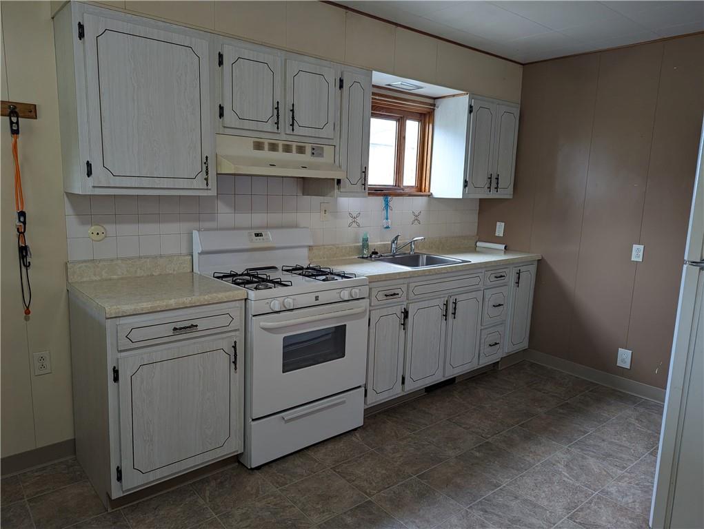 210 Sarah Street McKees Rocks, PA 15136 - Photo 8 of 12 a kitchen with stainless steel appliances granite countertop white cabinets sink and window
