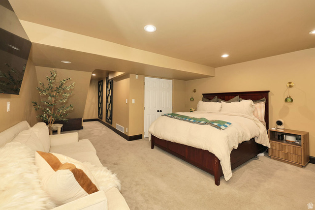 3104 East High Danish Road Sandy, UT 84093 - Photo 31 of 36 basement family room currently being used as primary bedroom. Carpeted bedroom area featuring recessed lighting, a built-in entertainment niche, and a contrasting dark baseboard trim