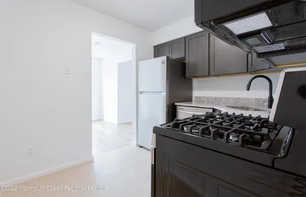 a kitchen with a refrigerator and a stove
