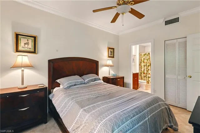 a bedroom with a bed and lamp