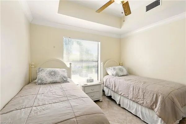 a bedroom with a large bed and a night stand