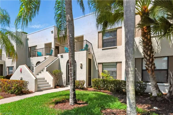 a front view of a house with yard and green space