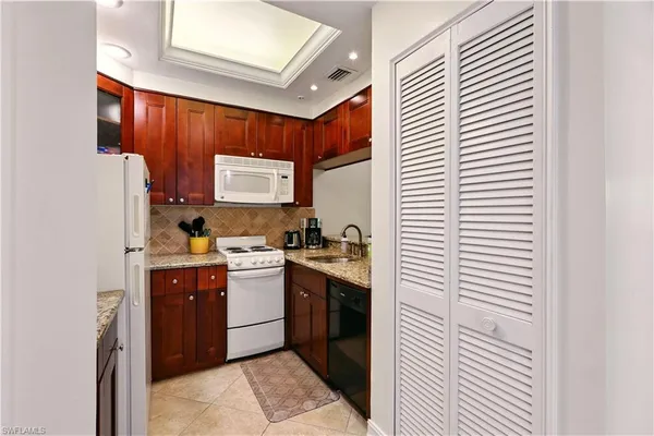 a kitchen with stainless steel appliances granite countertop a sink and cabinets