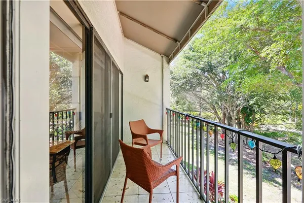 a view of a balcony with furniture