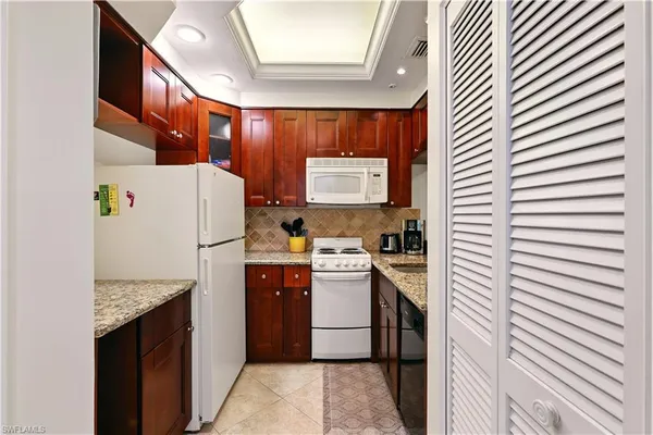 a kitchen with a refrigerator and a sink
