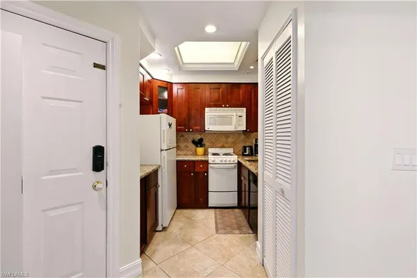 a kitchen with a refrigerator and a sink