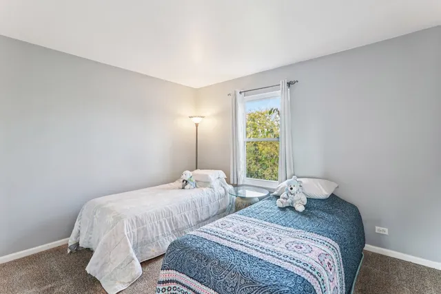 a bedroom with two beds and a window