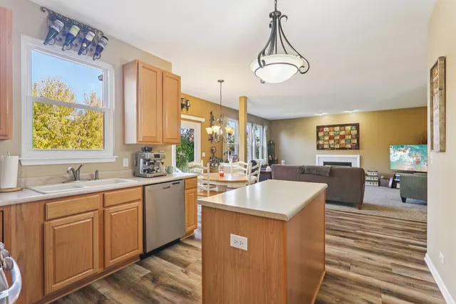 a very nice looking kitchen with granite countertop a sink window and cabinets