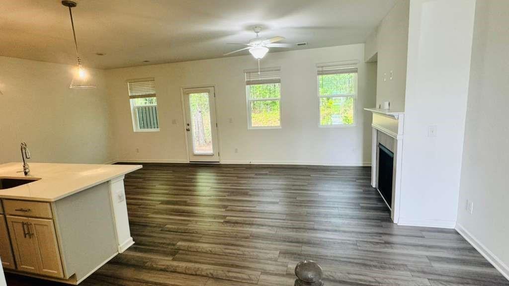 4078 Haleston Road Duluth, GA 30097 - Photo 4 of 25 a view of a kitchen with wooden floor and a ceiling fan