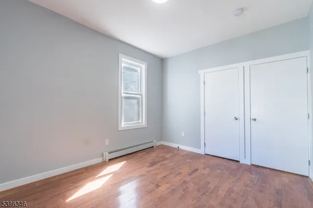 a view of an empty room and wooden floor