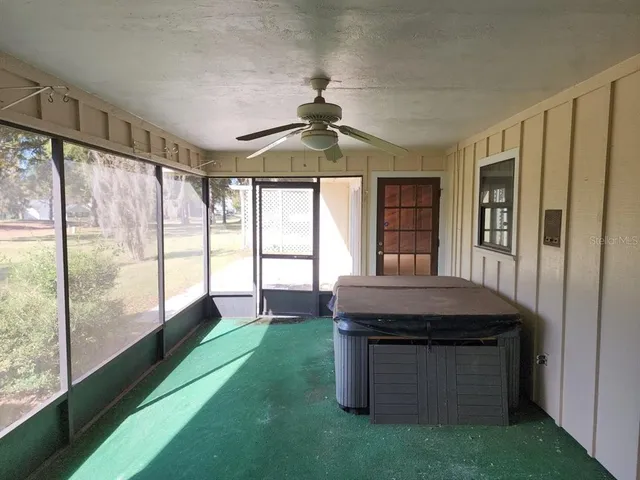 a room with pool table and windows