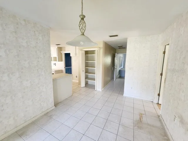 a view of a kitchen with a sink and dishwasher cabinets