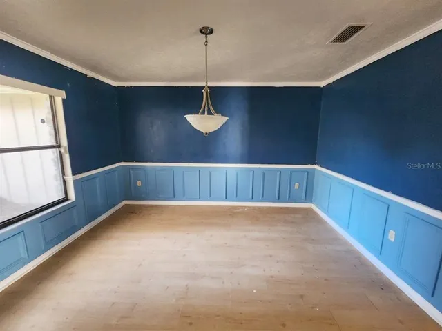 a view of a room with window and wooden floor