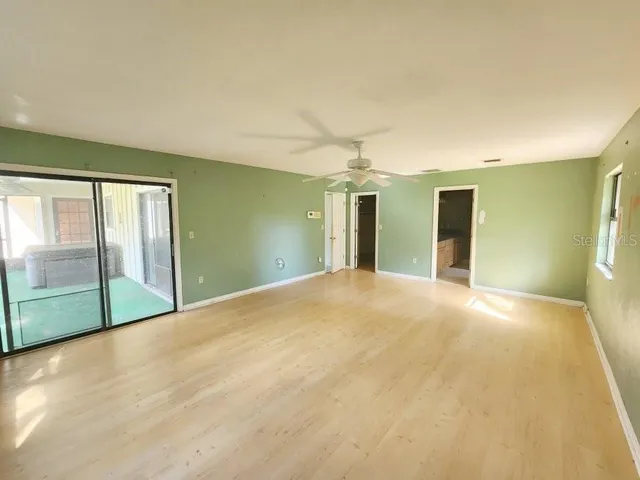 a view of empty room with floor to ceiling window