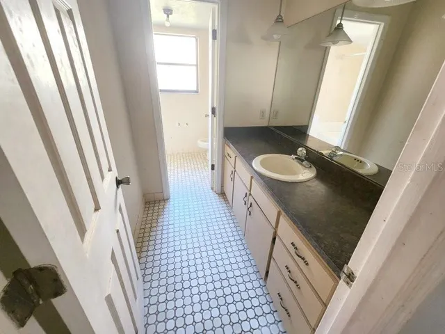 a bathroom with sink a toilet a mirror and shower