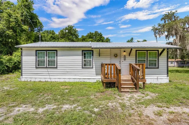a view of a backyard with a patio