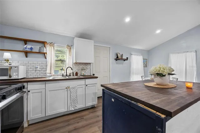 a kitchen with sink cabinets and wooden floor