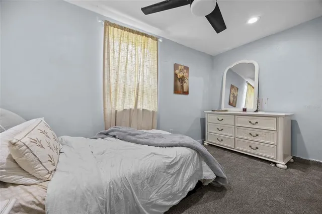 a bedroom with a bed and a dresser