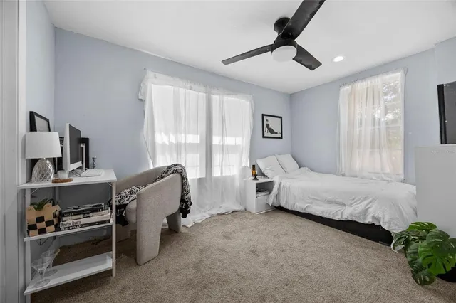 a spacious bedroom with a bed and window