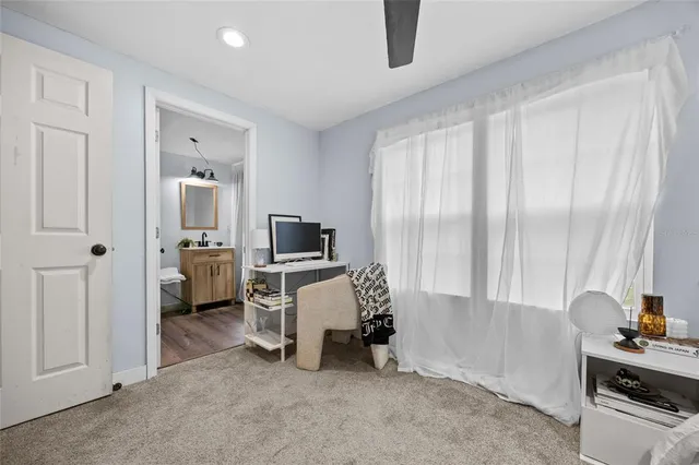 a view of a workspace with furniture and a window