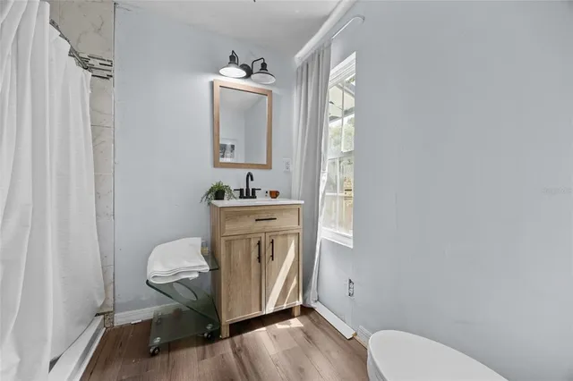 a bathroom with a toilet a sink and mirror