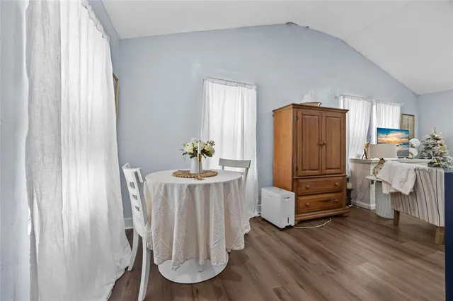 a room with wooden floor and furniture