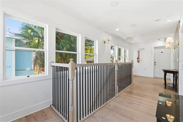 a view of a hallway with windows and stairs