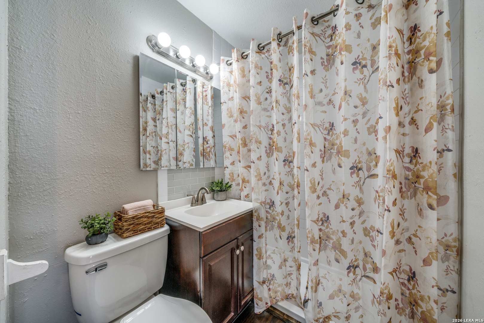 2307 Basse Road San Antonio, TX 78213 - Photo 16 of 17 a bathroom with a toilet sink and shower curtain