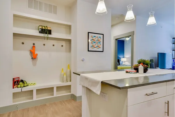 a kitchen with a sink cabinets and wooden floor