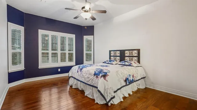 a bed sitting in a bedroom next to a window