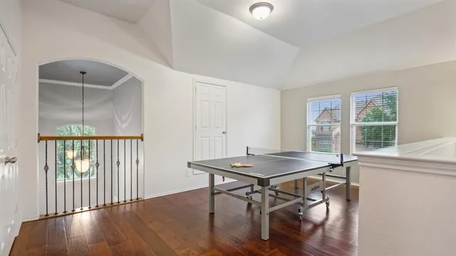 a room with pool table and a chandelier