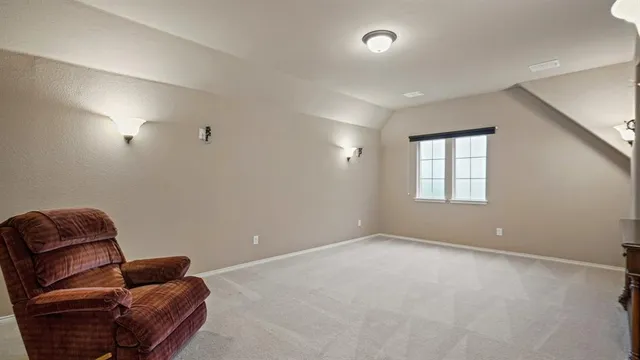 an empty room with furniture and natural light