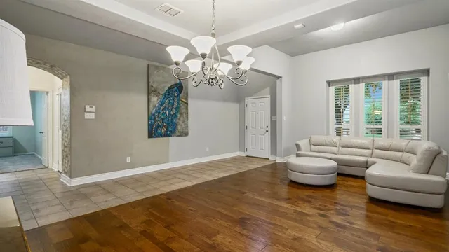a living room with furniture and a chandelier